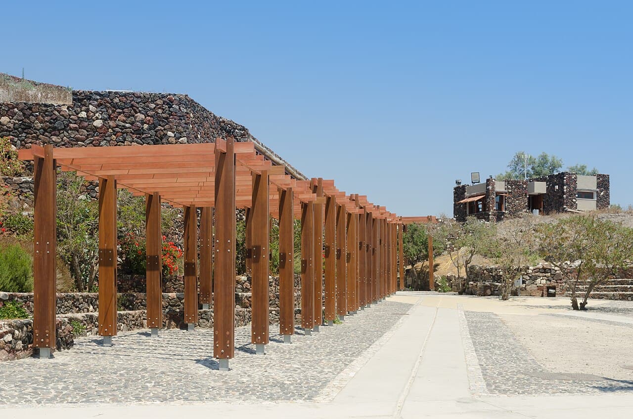 The Akrotiri archaeological site under its bioclimatic shelter. The streets and house corners are the same surfaces the inhabitants walked on around 1600 BCE.