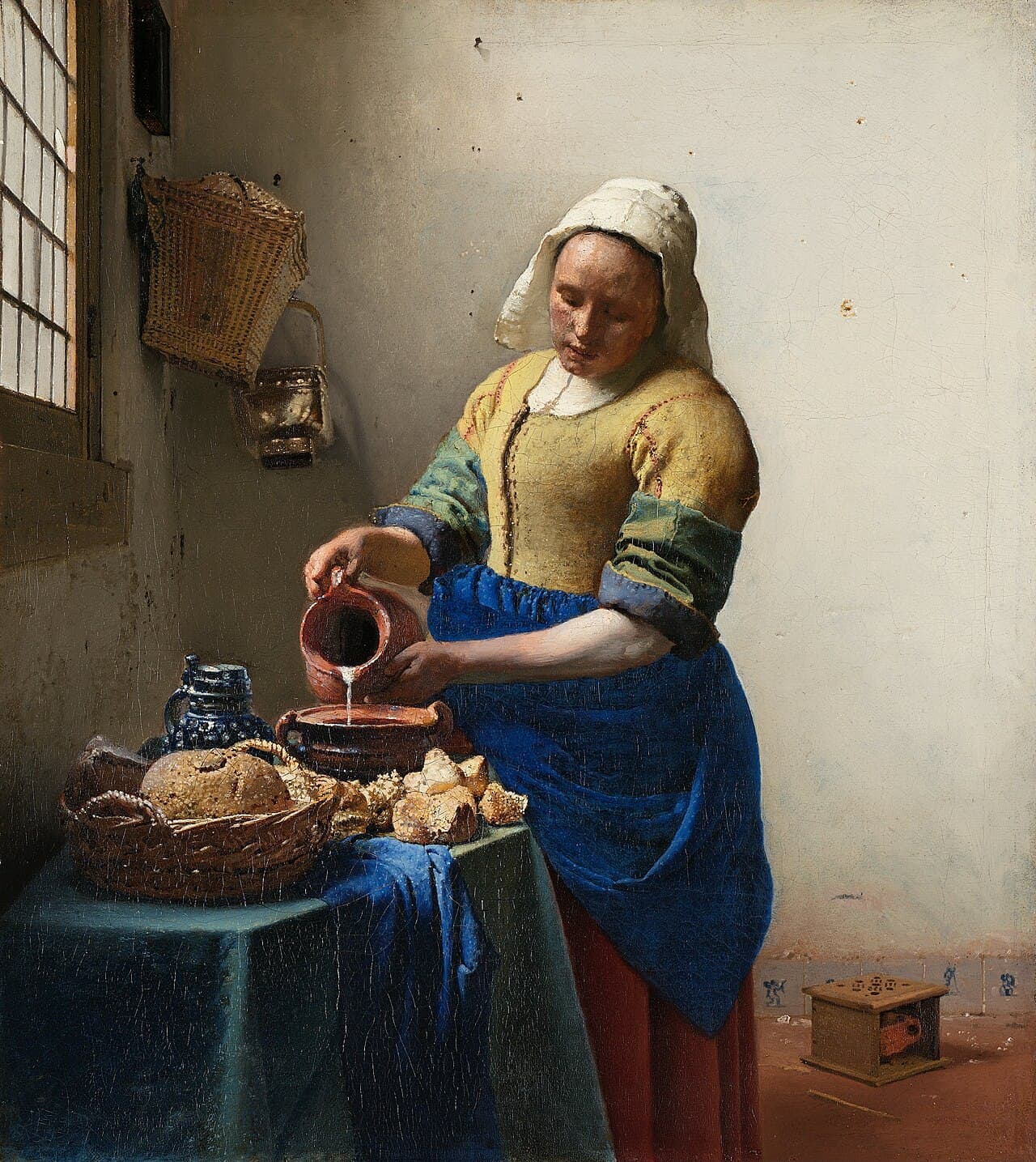 The Milkmaid (c. 1660). The discrete circular highlights on the bread crusts have been read as 'bokeh' — the signature of an optical projection.
