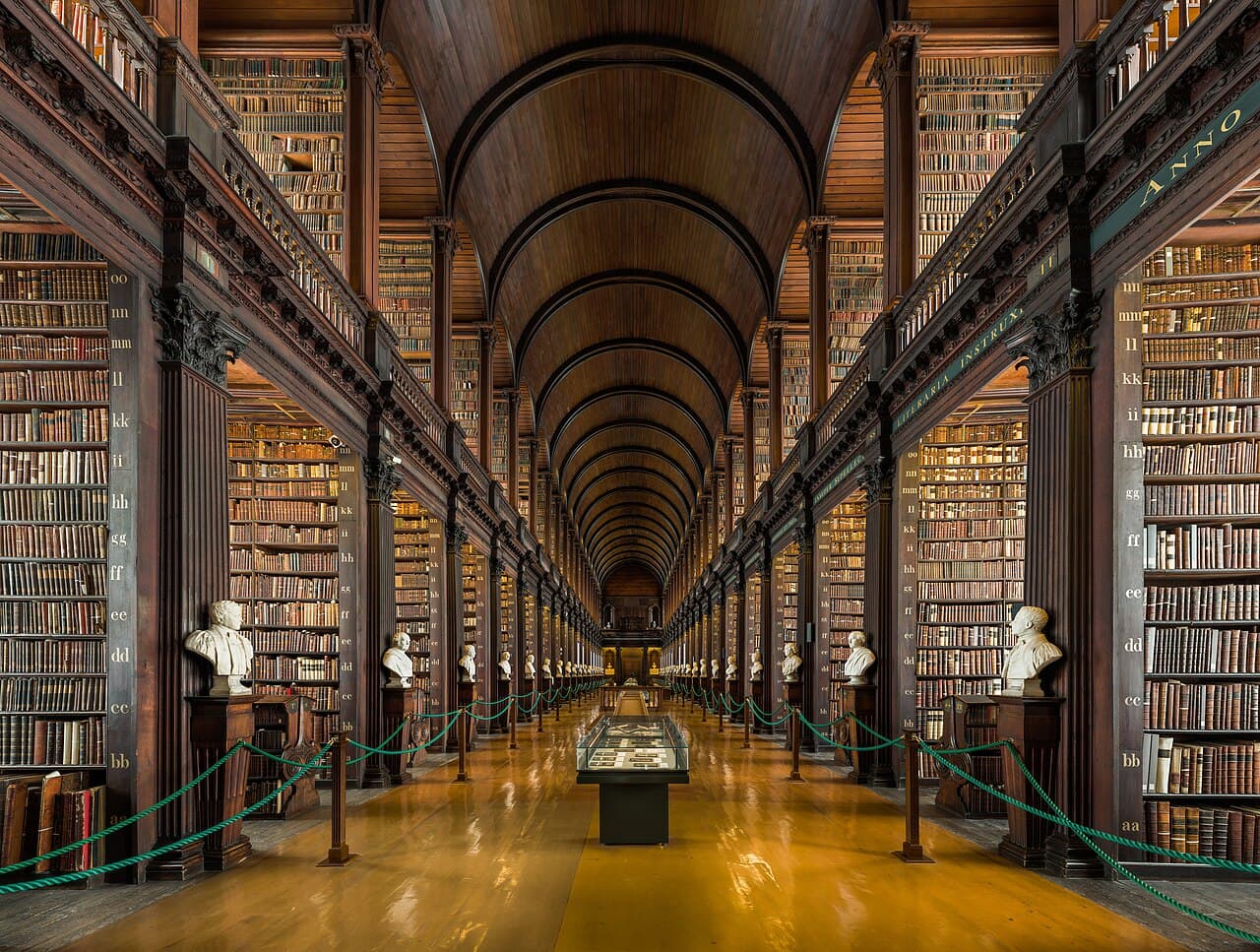 The Long Room at Trinity College Dublin. Borges's Library is finite but its contents exceed any imaginable physical library; the structure he described has been compared with great libraries from El Escorial to Trinity.