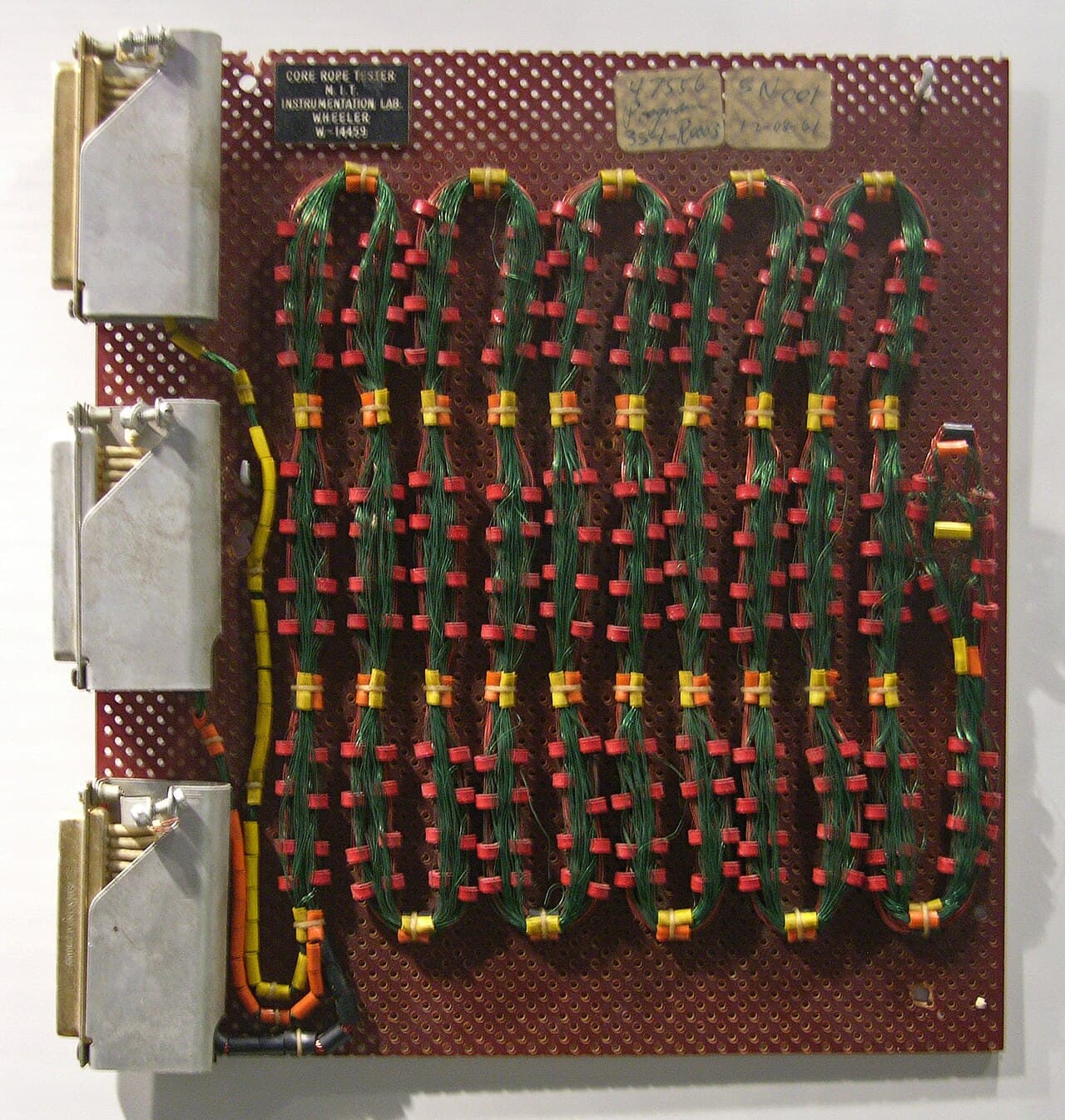 Core rope memory: each bit of the AGC's program was physically encoded by whether a copper wire ran through or around a ferrite core. Programs were woven, by hand.