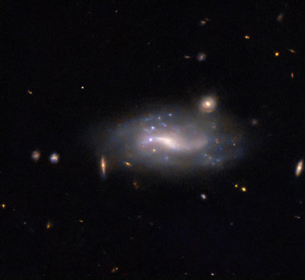 A type Ia supernova at the lower-left of its host galaxy. The remarkable consistency of these explosions in peak brightness makes them standard candles for measuring cosmic distances.